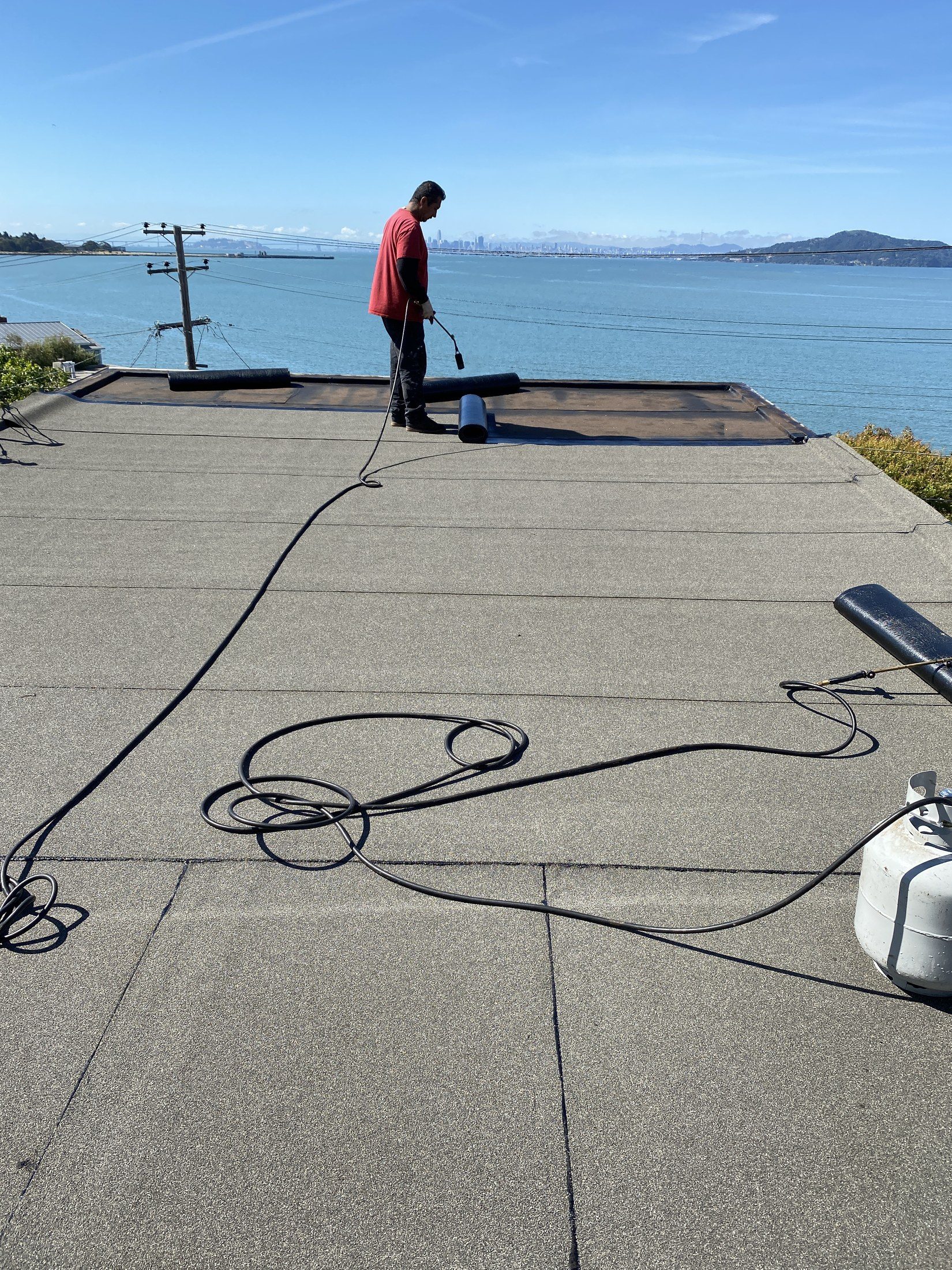 R2L Roofing completing a commercial flat roof with a Bay Area view